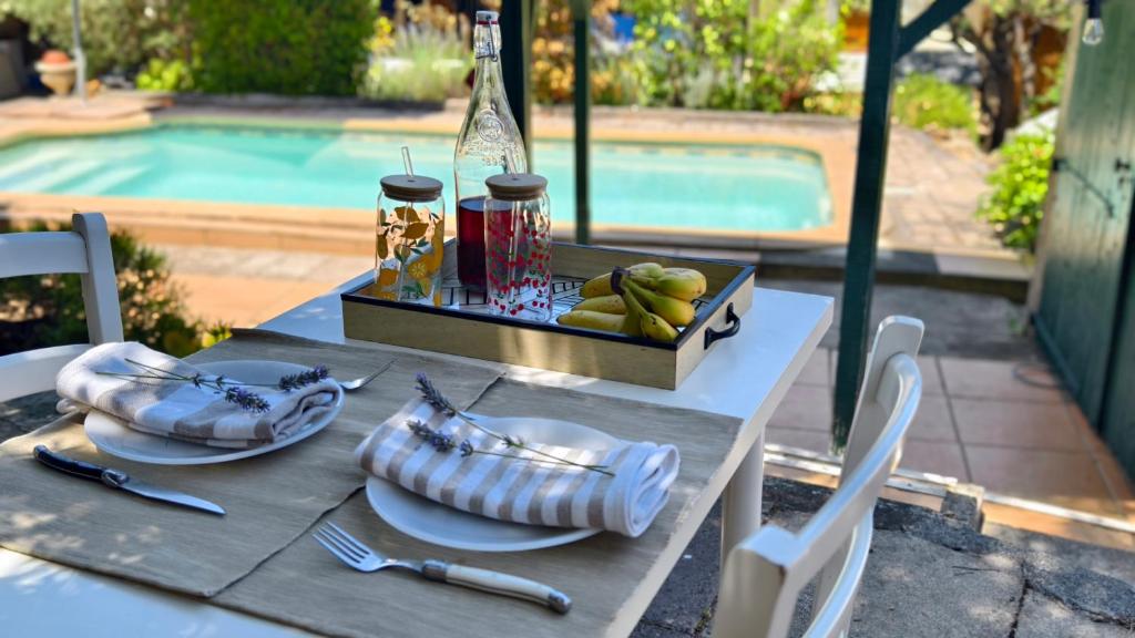 a table with a plate of food and a bowl of fruit at Cozy studio in medieval town in Le Val
