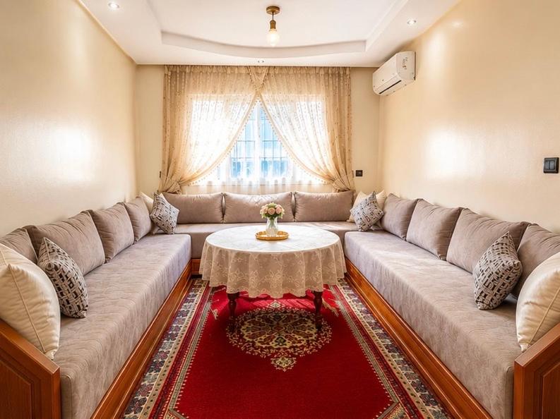 a living room with a large couch and a table at Spacious Apartment Casablanca in Casablanca