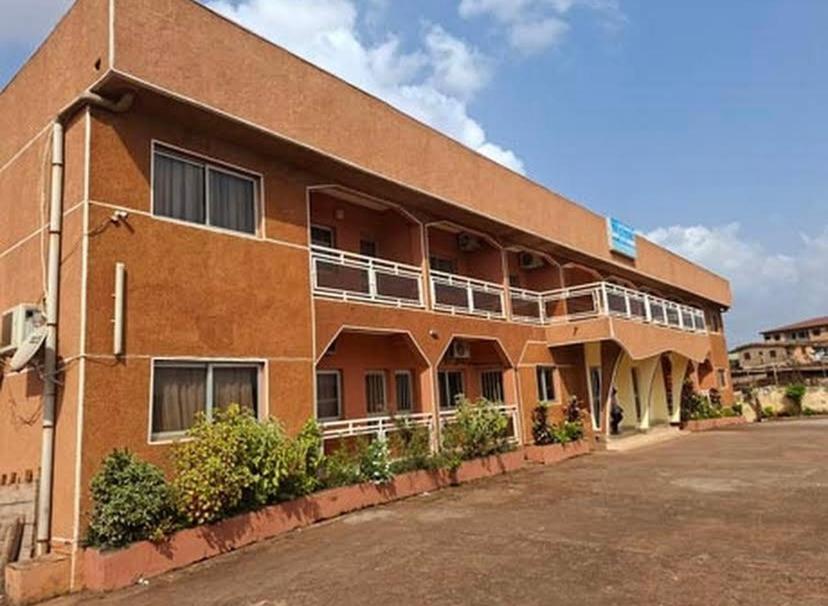 a building with balconies on the side of it at Hôtel Les Pyramides in Yaoundé