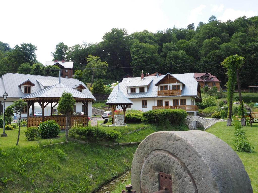 a house with a large tire in front of it at Młyn Bosaka in Ojców
