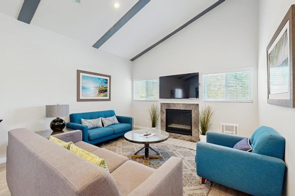 a living room with blue couches and a fireplace at San Clemente - Villa Del Mar in San Clemente