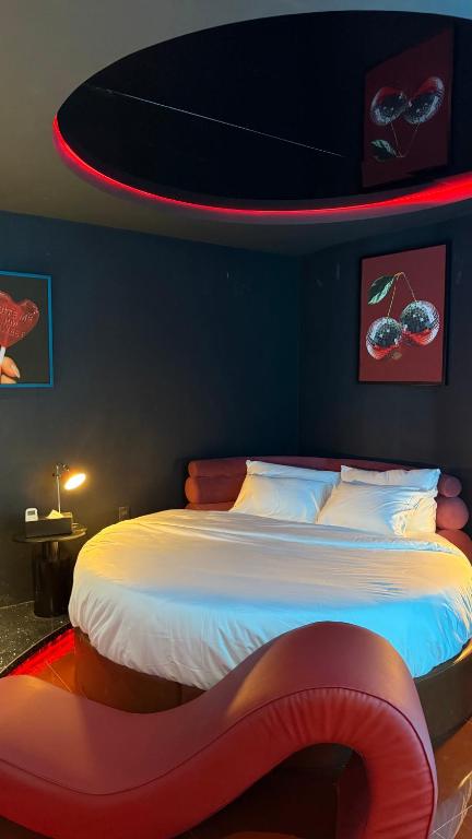 a bedroom with a large bed with a red lightedppelin at Benri Hotel Signature in Ho Chi Minh City