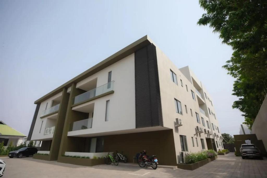 a building with two motorcycles parked in front of it at Wentworth - SKYSUITES in Accra