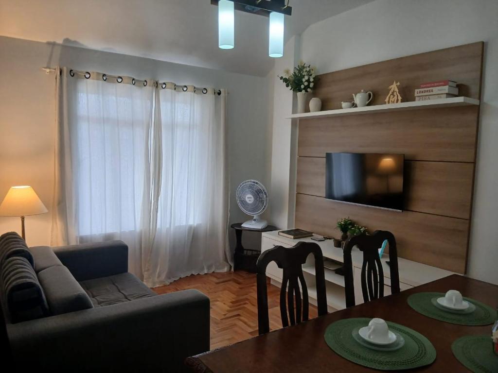 a living room with a couch and a dining room table at Ita Green in Teresópolis