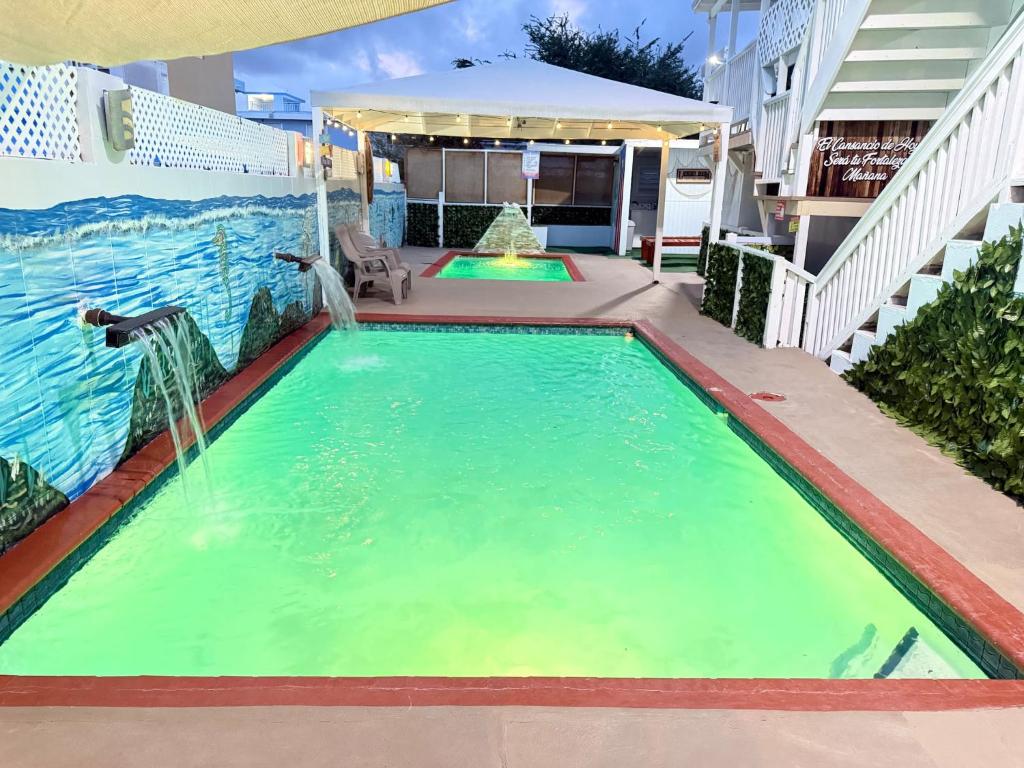 an indoor swimming pool with a water fountain at 2 Pools - Solar - Playa Santa - Apto E in Guanica