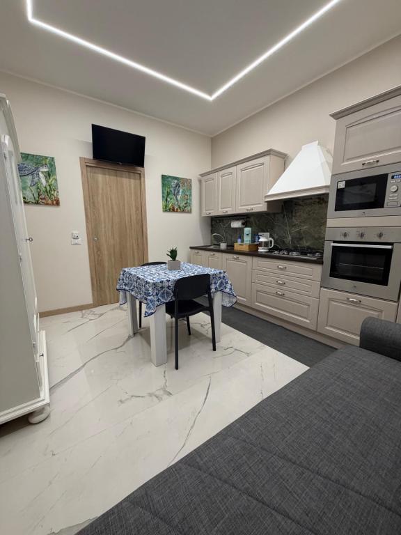 a kitchen with a table in the middle of it at Catalano Suite Marina - Vista Mare in Palermo