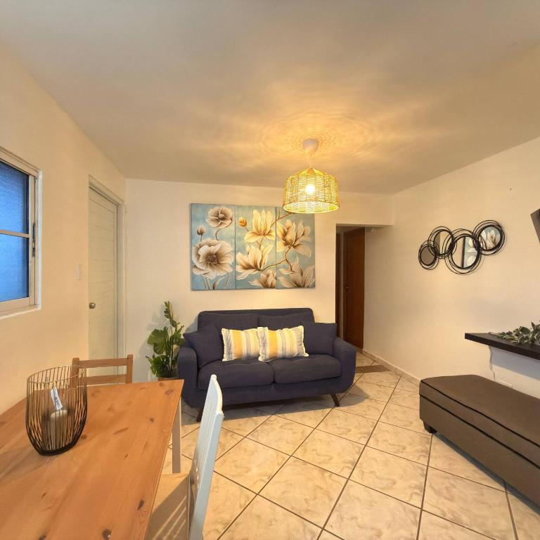 a living room with a couch and a table at Spacious 2BR Apt - Kitchen - Laundry - WiFi in Yauco