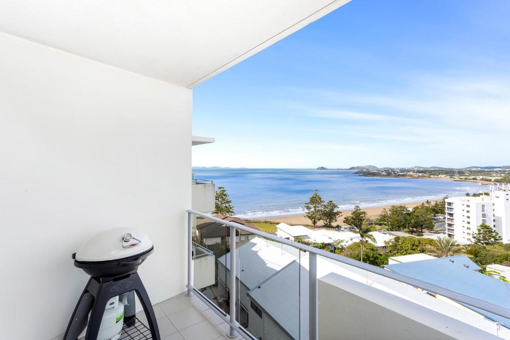 a balcony with a view of the beach at 'Still & Sea' in Yeppoon's CBD in Yeppoon