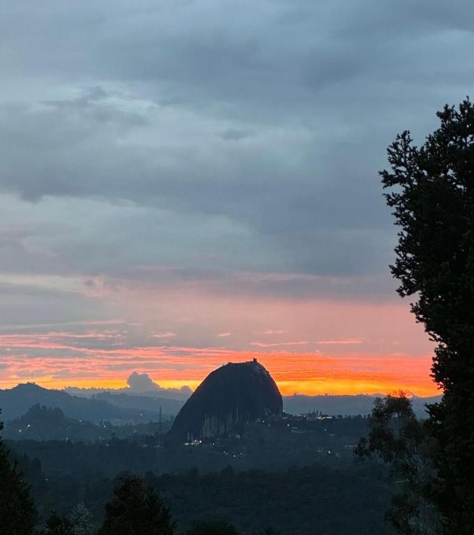 a view of a mountain at sunset at Casa Solar in Guatapé