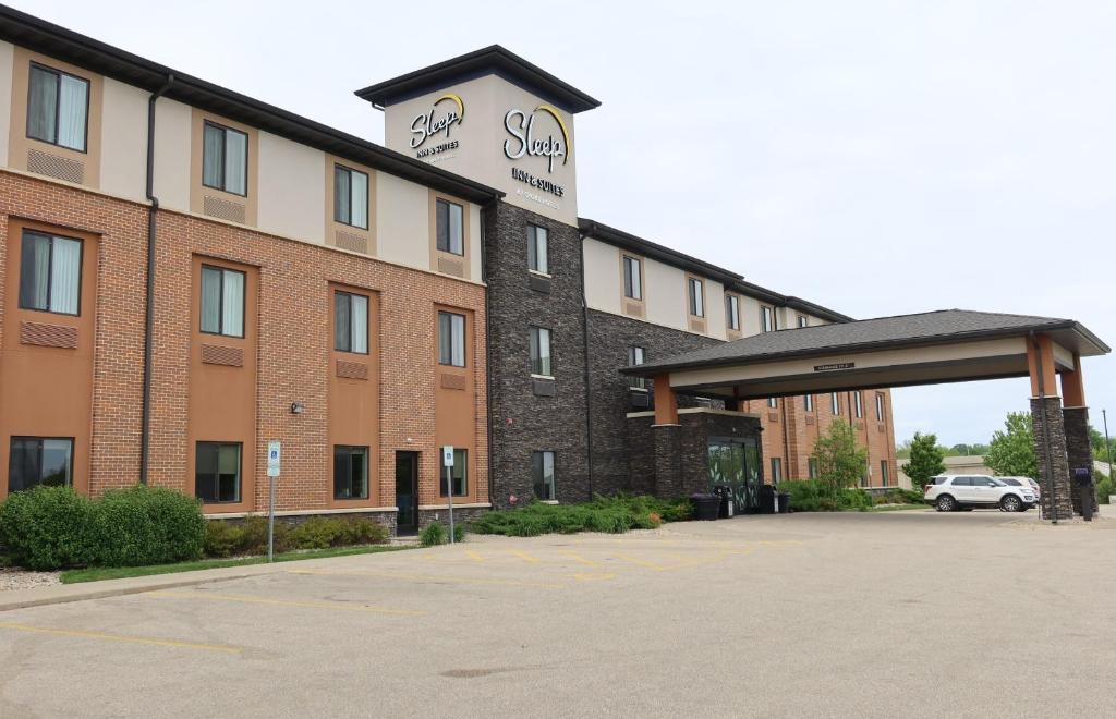 a hotel with a parking lot in front of it at Sleep Inn & Suites Oregon - Madison in Oregon