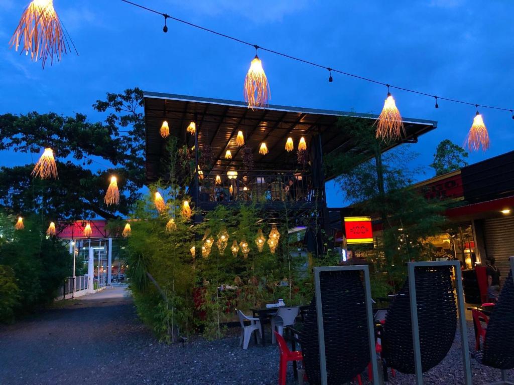a building with lights hanging from it at night at Cafe Moto Hostel in Puerto Princesa City