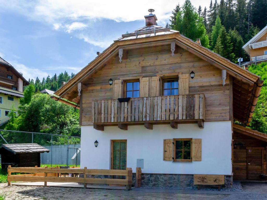 a wooden house with a balcony on top of it at Chalet Cornelia in Gatschberg