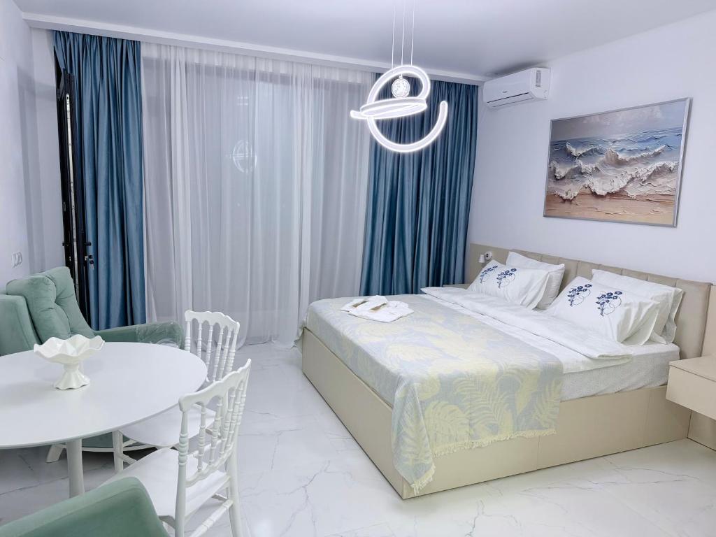 a bedroom with a bed and a table and chairs at Alisa's apartments Ureki in Ureki