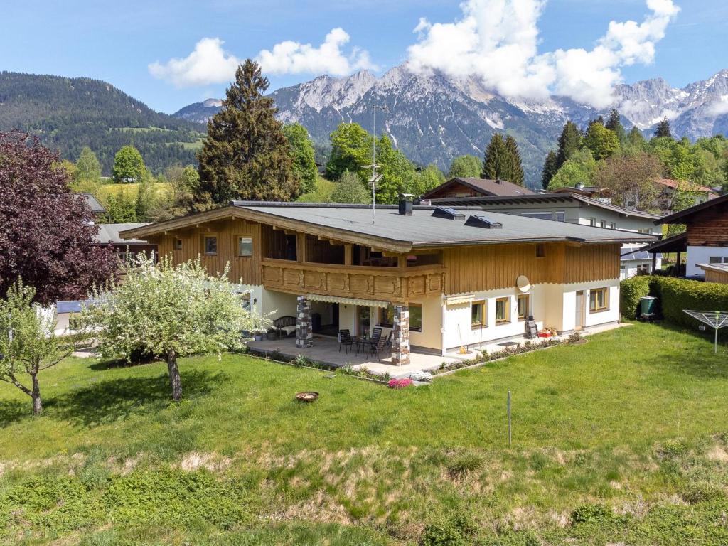 an aerial view of a house with mountains in the background at Das Bergnest Dorfglück in Söll