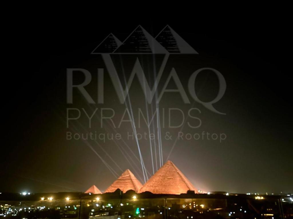 a view of the pyramids at night at Riwaq Pyramids View Inn & Rooftop in Cairo