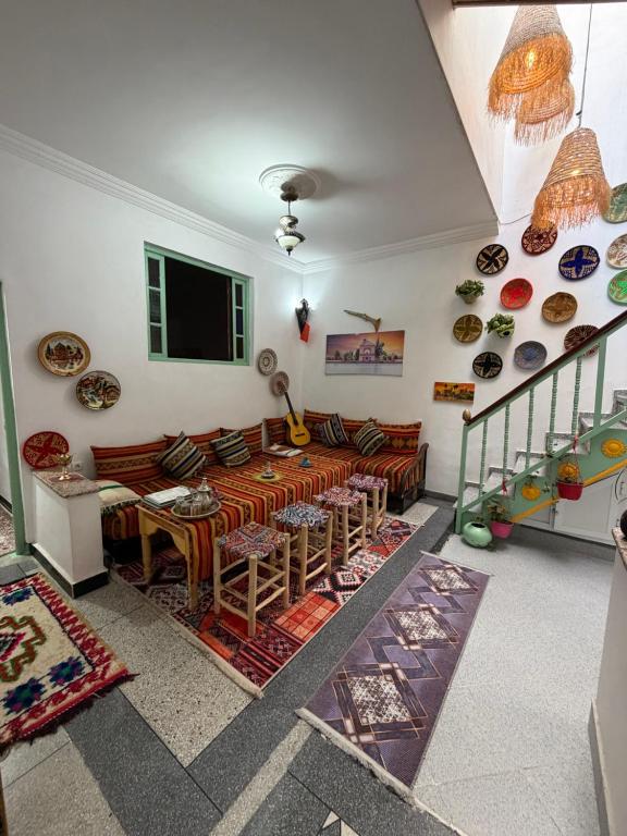 a living room with a couch and a table at Riad dar sahrawi in Marrakesh