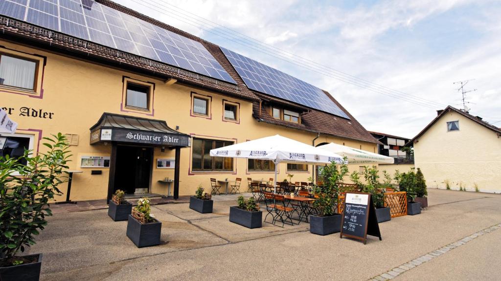 a building with solar panels on the side of it at Gasthaus Schwarzer Adler in Holzgünz
