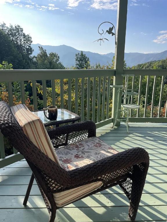a wicker chair and a table on a porch at Mountain View Paradise by Avada Properties in Gatlinburg