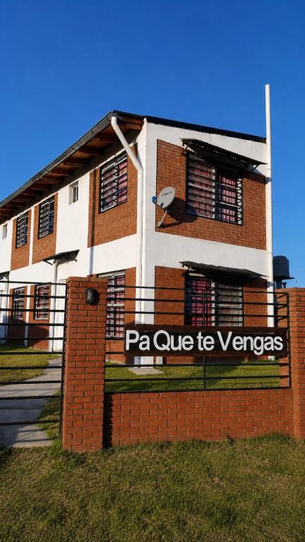 a building with a sign on the side of it at Cabañas Pá Que te Vengas in Trapiche