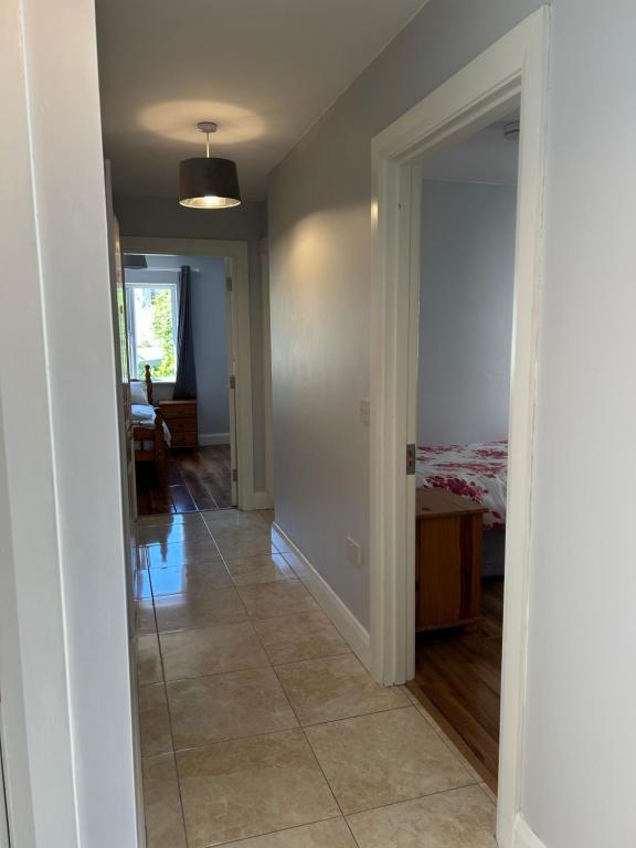 a hallway with a room with a bed and a door at Teach Fáilte in Sligo