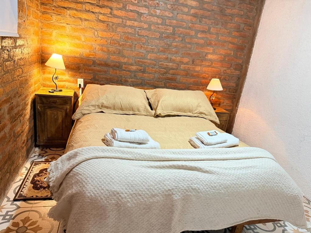 a bedroom with a bed with two towels on it at Alojamiento en Barreal, San Juan in Barreal