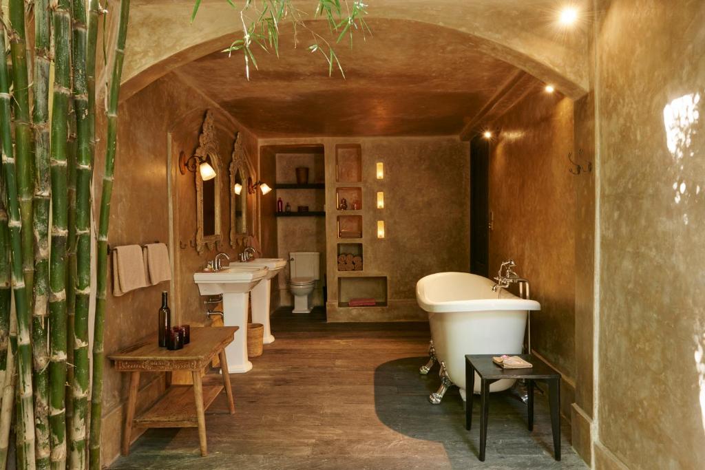 a large bathroom with two sinks and a tub at The Island Houses Seminyak in Seminyak
