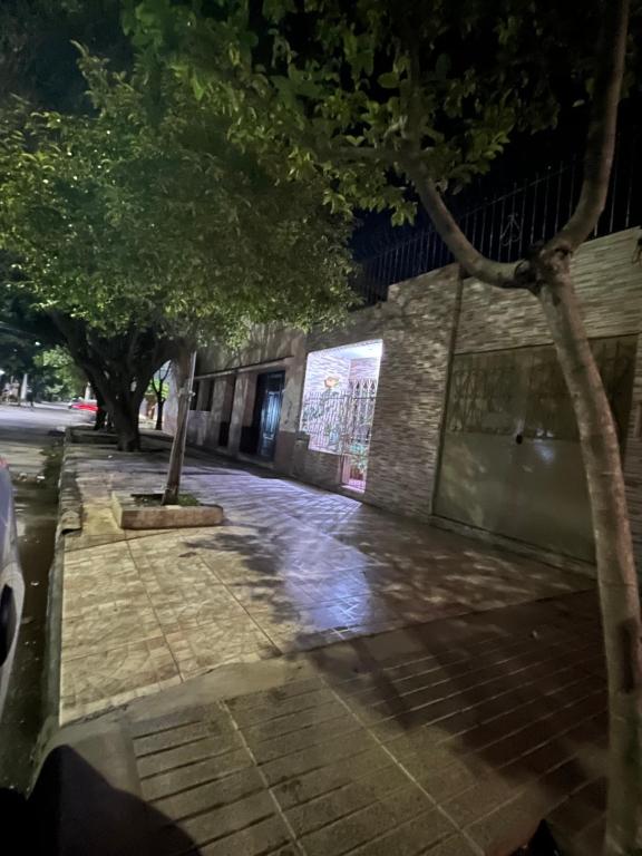 a sidewalk with trees in front of a building at Casa Chicho in Santiago del Estero