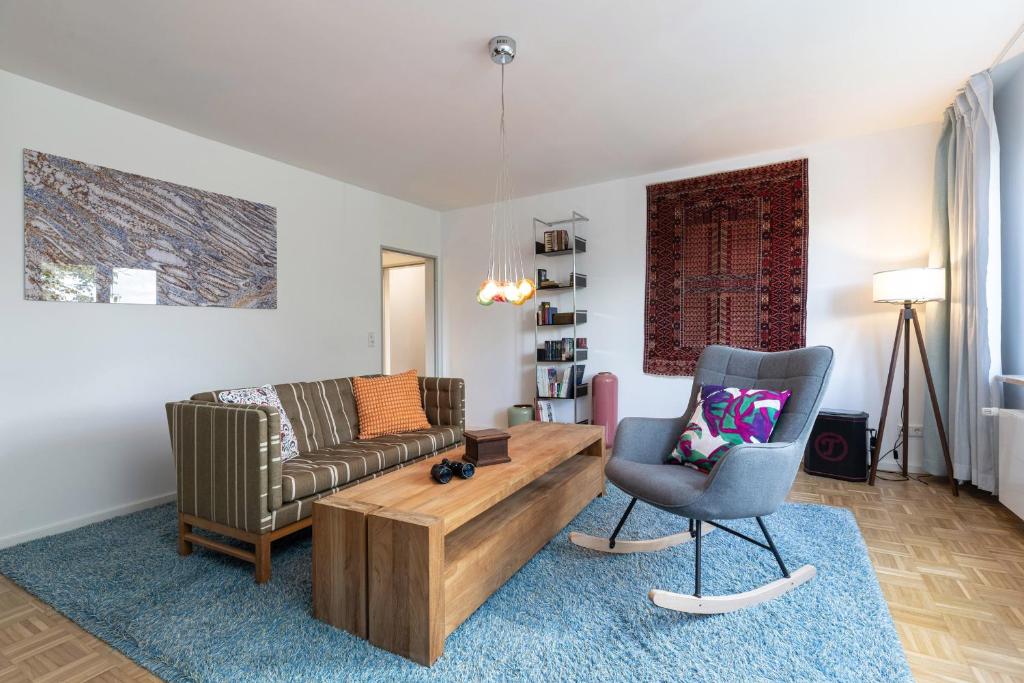 a living room with a couch and a chair at Treibholz in Schönberg