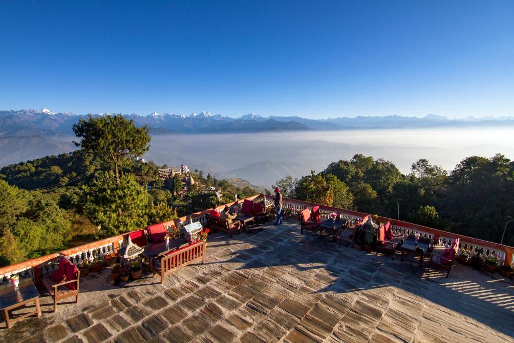 a group of tables and chairs on top of a mountain at Peaceful Cottage & Cafe Du Mont in Nagarkot