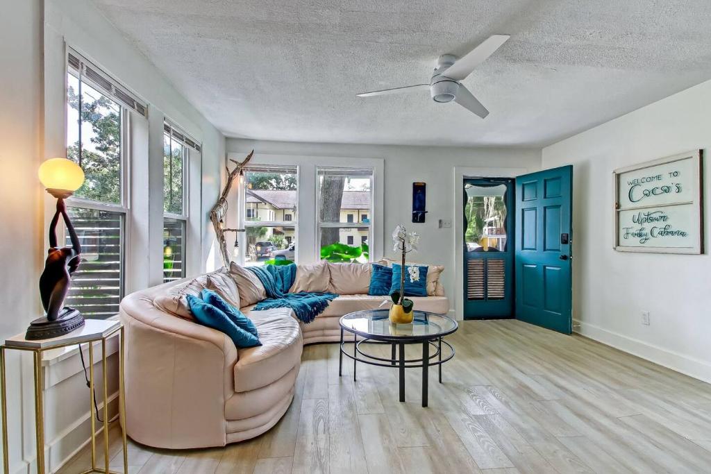 a living room with a couch and a table at Charming St Augustine Oasis with Game Room for Family fun in St. Augustine