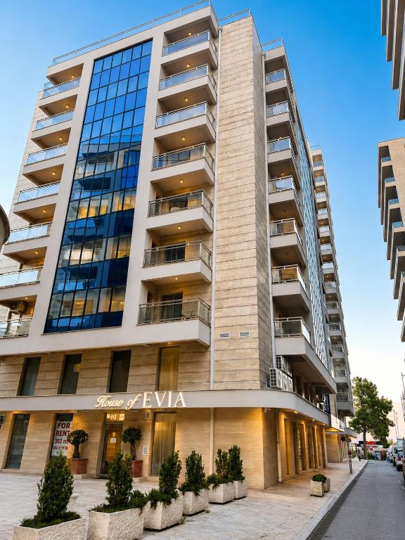 a tall building with a sign on it at FONTANA DELUXE Apartment in Budva