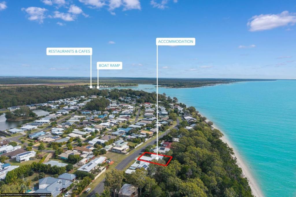 an aerial view of a beach with houses and the ocean at Absolute Beachfront Retreat - Private Beach TOOGOOM in Fraser Island