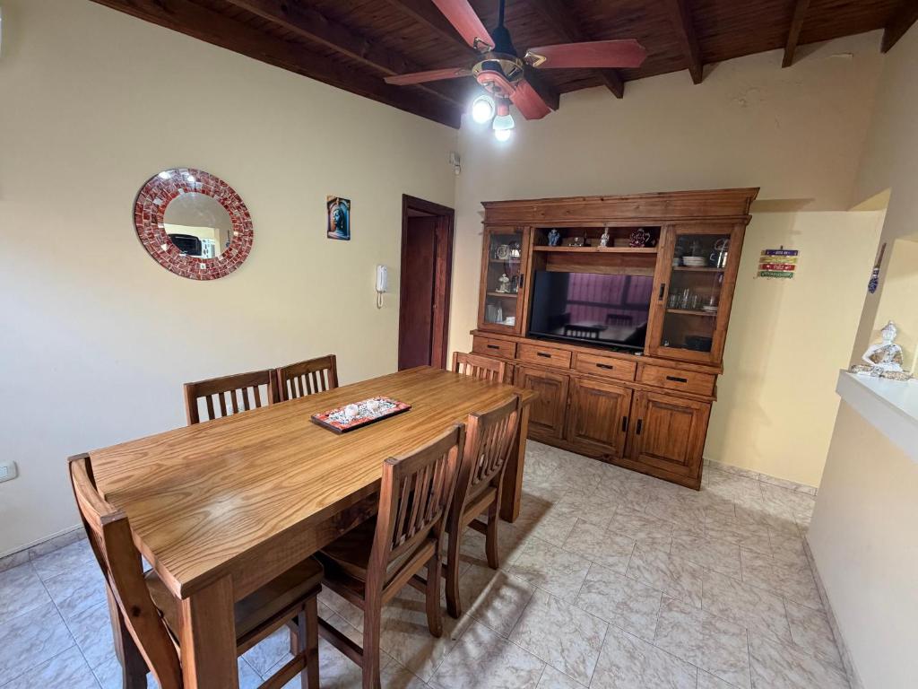 a dining room with a wooden table and chairs at Refugio serrano in Tandil