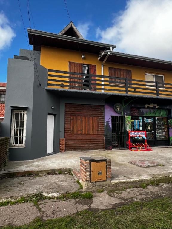 a house with a balcony and a garage at Costa Edison in Mar del Plata