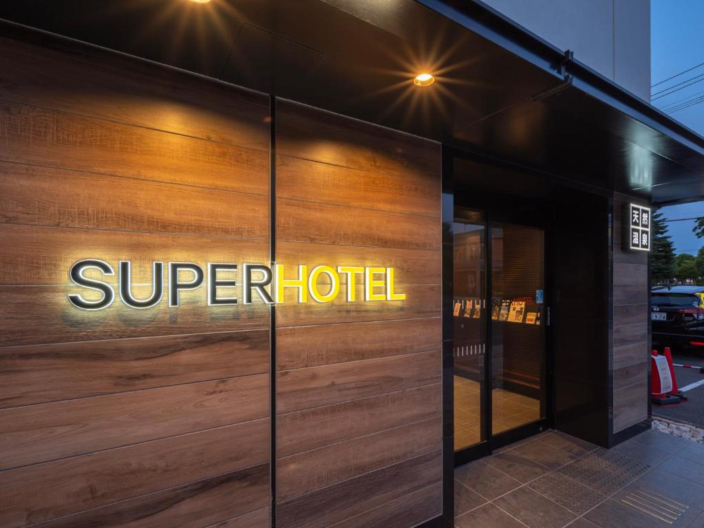 a sign on the side of a super hotel at Super Hotel Asahikawa in Asahikawa