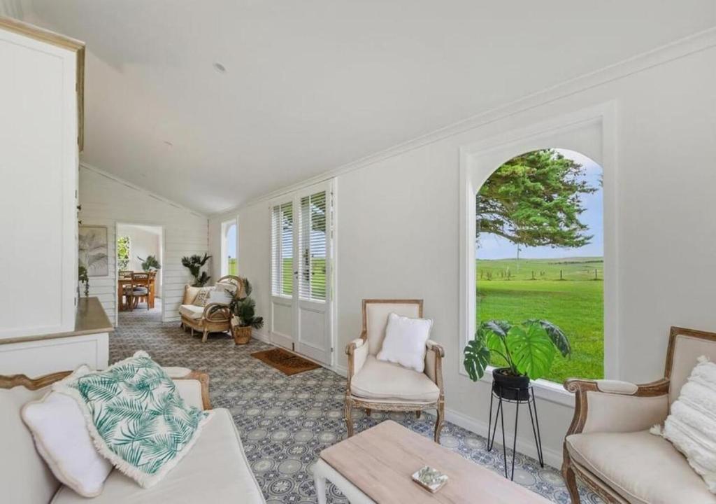 a living room filled with furniture and a large window at Cork Hill Retreat in Cape Bridgewater