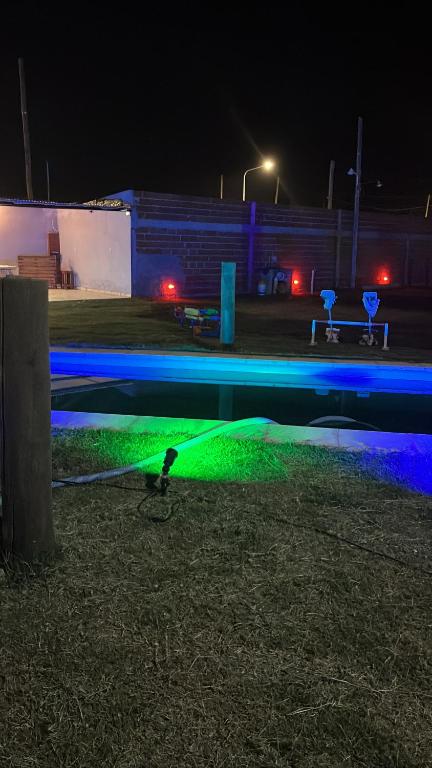 a bird standing next to a pool of water at night at El triángulo finca familiar in Maco