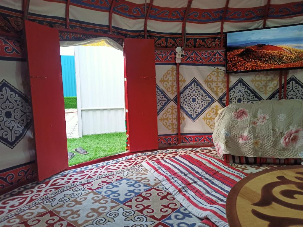 a bedroom with a bed with a red and blue pattern at Laguna Relax in Balqash