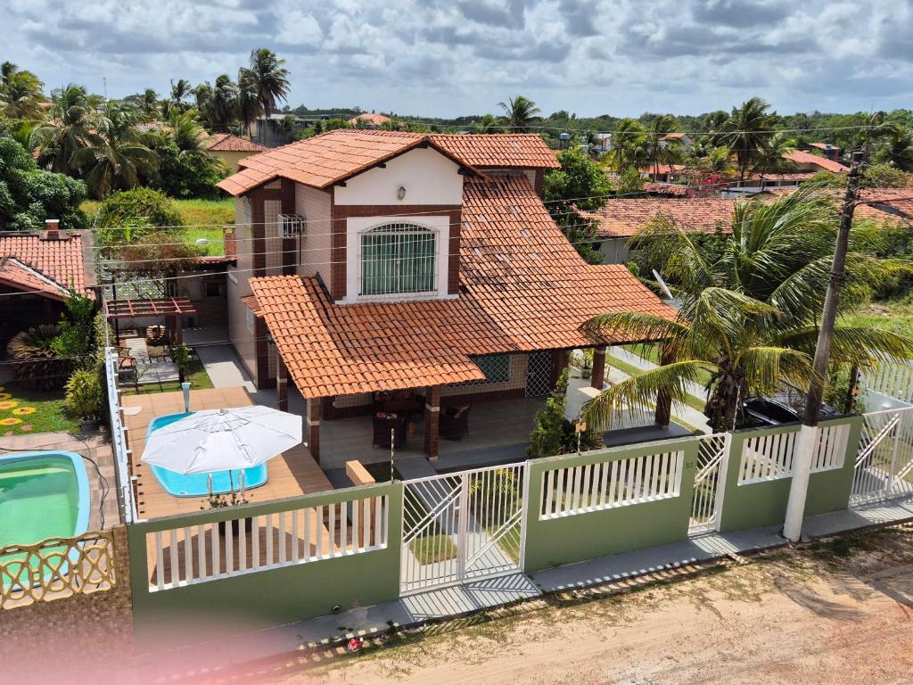 an aerial view of a house with a deck with an umbrella at Casa em Salinas in Salinópolis