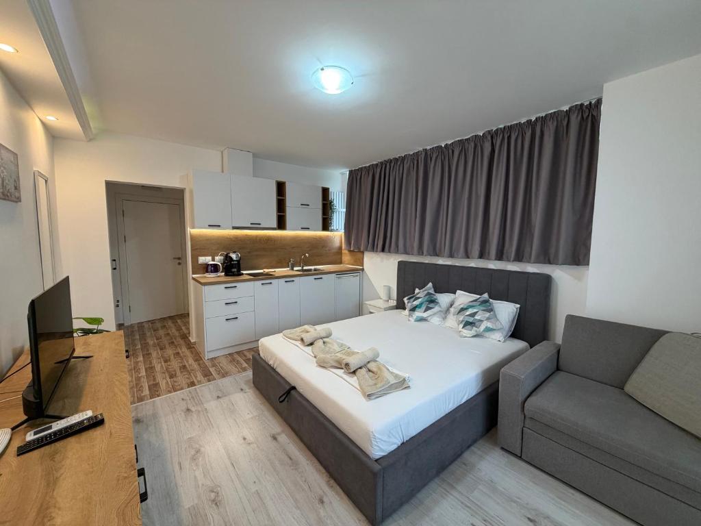 a small bedroom with a bed and a couch at Студио Симона 5 първа линия море in Lozenets