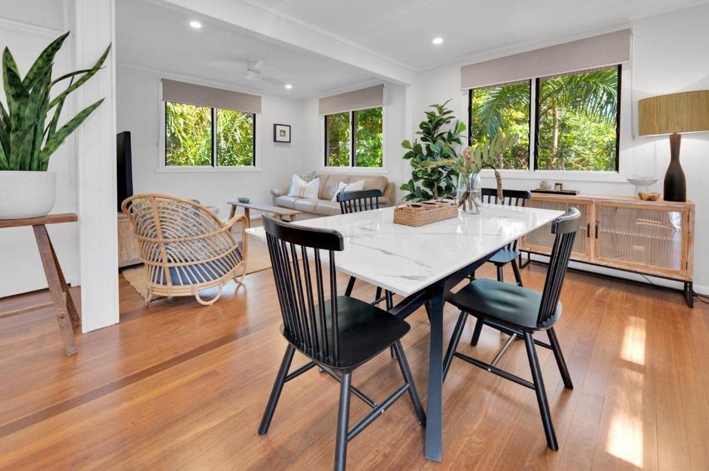 a dining room and living room with a table and chairs at Birdwing Retreat in Picnic Bay