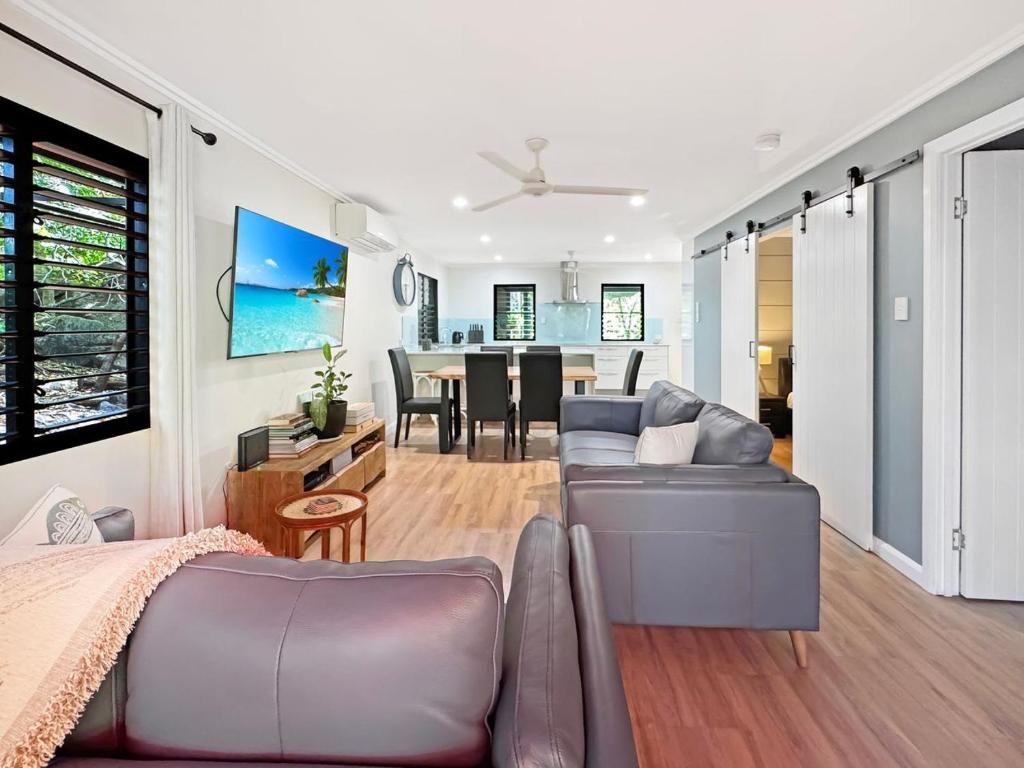 a living room with a couch and a dining room at Alma Rocks in Arcadia