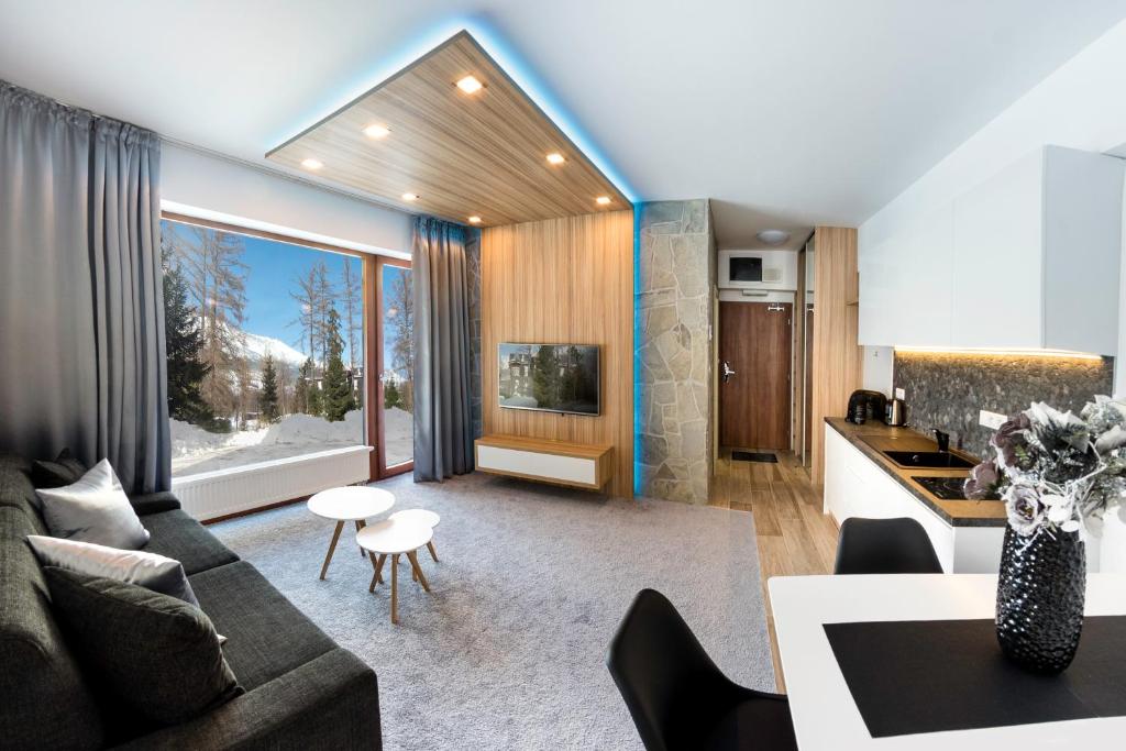 a living room with a couch and a table at Apartment Luna Hrebienok in Vysoke Tatry - Stary Smokovec