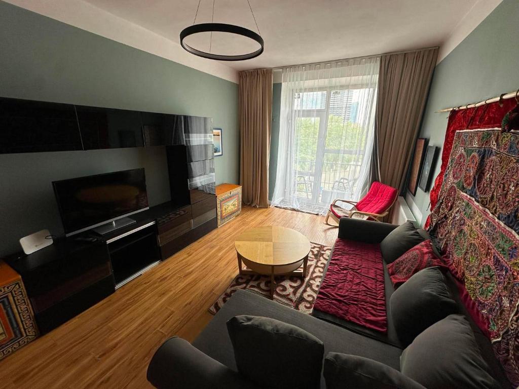 a living room with a couch and a table at Russian Embassy Apartment in Ulaanbaatar