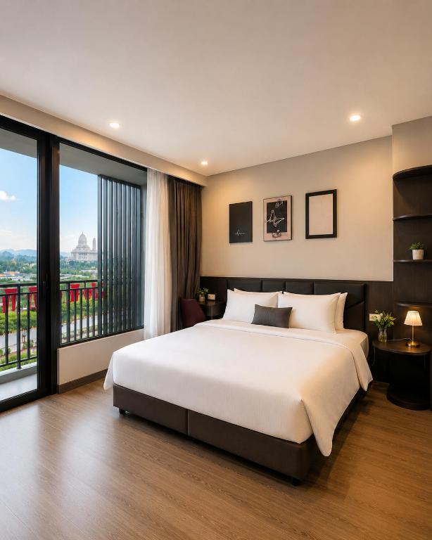 a bedroom with a large bed and a large window at Coline Hotel & Aparment in Ninh Binh