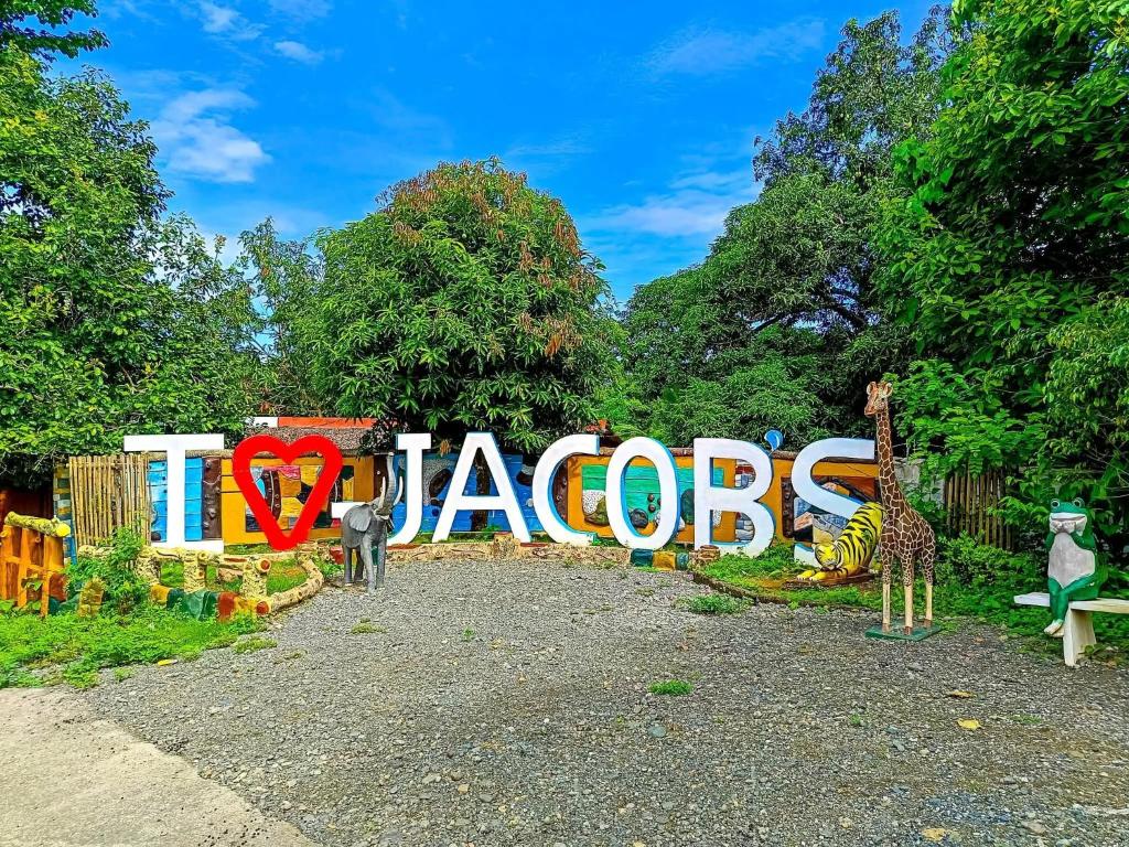 a zoo exhibit with giraffes and a sign that says zoos at Jacob's Well Resort in Rizal