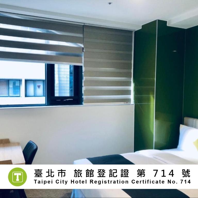 a hotel room with a bed and a window at T.O. Hotel - Taipei station in Taipei