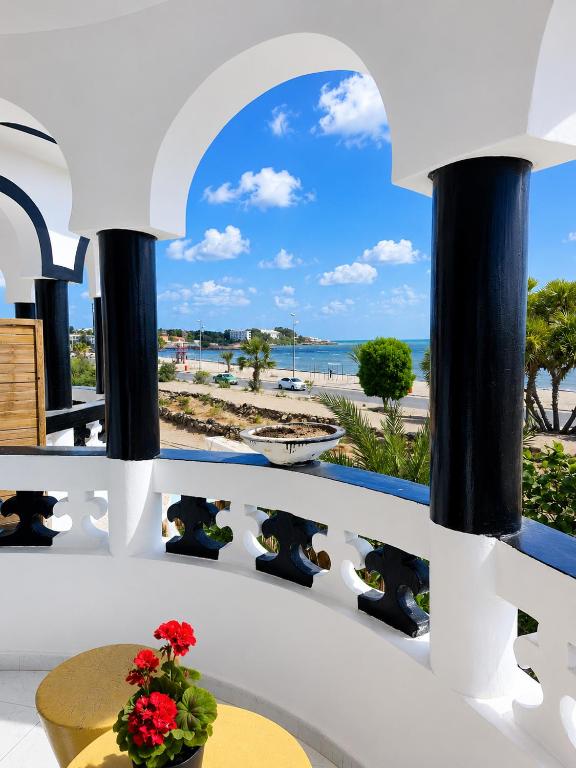 a view of the beach from the balcony of a building at Brise de Mer Apartment 3 Bedrooms in Djibouti