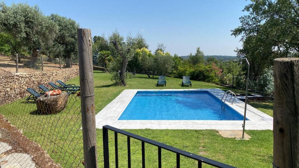 a swimming pool in a yard with a fence at Detached 4 Bedroom Villa with Pool in Valencia de Alcántara