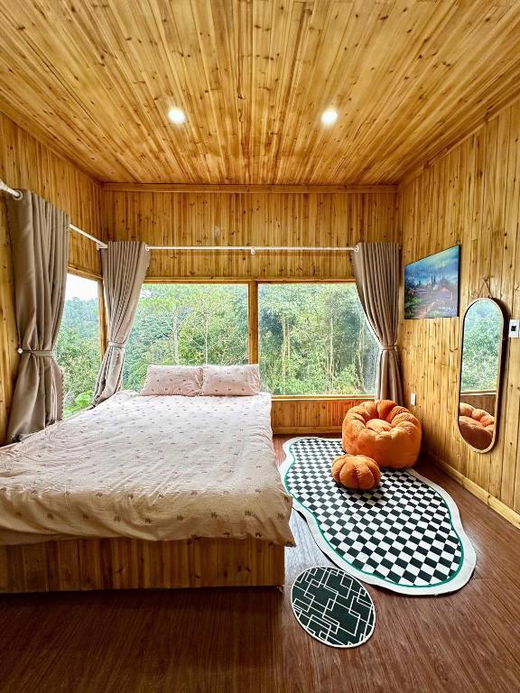 a bedroom with a bed and two pumpkins on the floor at Dốc Mơ Homestay in Bản Bé